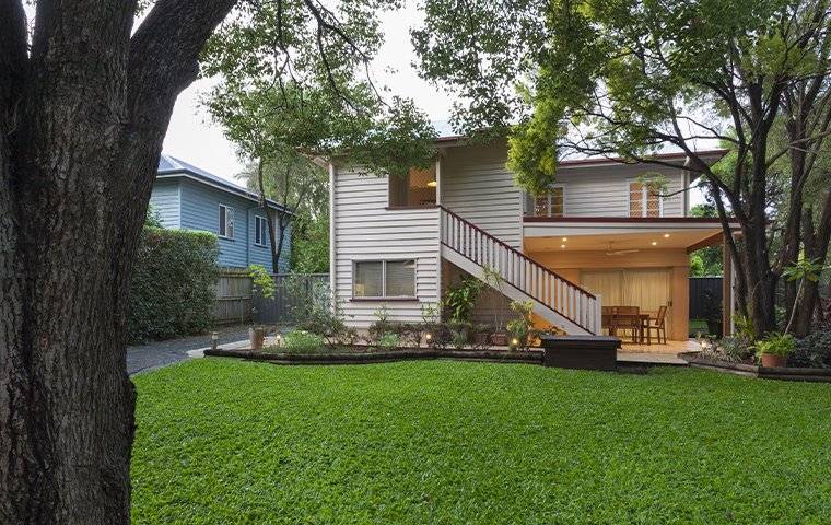 A house with a green lawn and a staircase in Irving, TX.